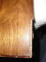 This  armoire door right side damage-closeup.
