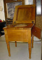 A childs antique commode after repairs.