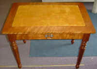 Refinished and the oil cloth was replaced with a tanned deer hide.