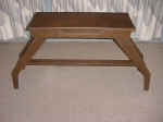 This dogleg organ bench is made of oak, now refinished ina walnut color.
