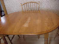 An Oak table protected by newspaper to clean oven racks. The result was a ruined finish.
