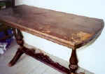 The top was loose from the base and the finish severely worn. 